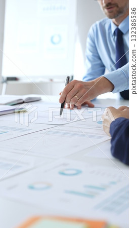 Business people analyzing financial charts and graphs during corporate meeting, focusing on data strategy, growth performance, and market planning Business people analyzing financial charts and graphs during corporate meeting, focusing on data strategy, growth performance, and market planning 132386586