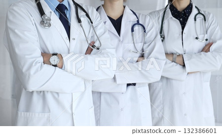 A group of doctors with folded arms demonstrates the professionalism of medicine, mutual support of clinics, and dedication to expert care in a hospital setting 132386601