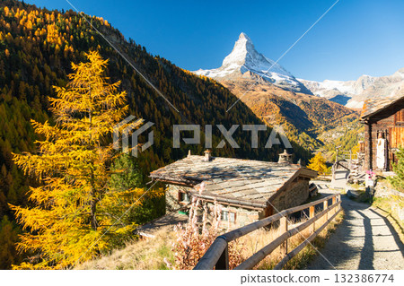 Matterhorn Mountain, Houses of Village and Yellow Larches in Autumn. Switzerland Matterhorn Mountain, Houses of Village and Yellow Larches in Autumn. Switzerland 132386774