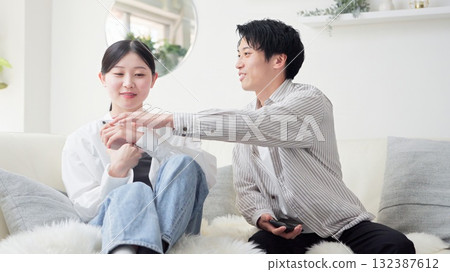 Asian couple arguing over smartphone Asian couple arguing over smartphone 132387612