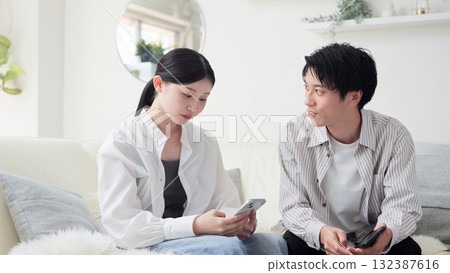 Asian couple arguing over smartphone 132387616