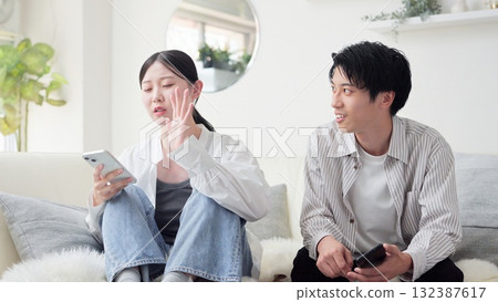 Asian couple arguing over smartphone 132387617