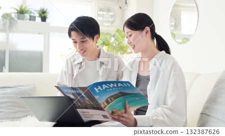 Asian couple discussing travel plans Asian couple discussing travel plans 132387626