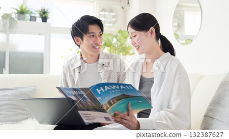 Asian couple discussing travel plans 132387627