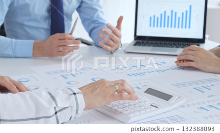 Accouters analyzing financial data using charts, graphs, and reports during an office meeting, collaborating on strategy. Business people concept Accouters analyzing financial data using charts, graphs, and reports during an office meeting, collaborating on strategy. Business people concept 132388093