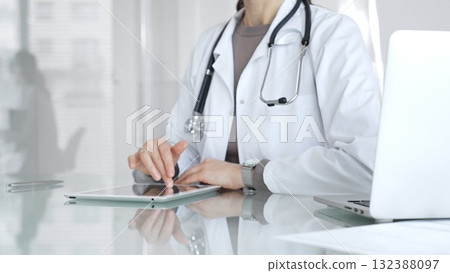 Doctor using digital tablet for remote medical consultation, providing modern healthcare services, telehealth concept. Medicine and health care Doctor using digital tablet for remote medical consultation, providing modern healthcare services, telehealth concept. Medicine and health care 132388097