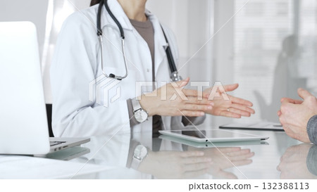 Female doctor consulting patient, explaining treatment options, discussing healthcare in clinic, providing medical advice. Medicine and health care Female doctor consulting patient, explaining treatment options, discussing healthcare in clinic, providing medical advice. Medicine and health care 132388113