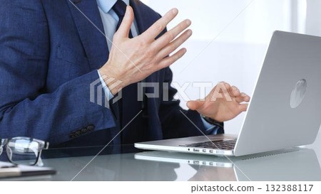 Businessman having a video conference, gesturing during an online business meeting or remote negotiation. Business people concept 132388117