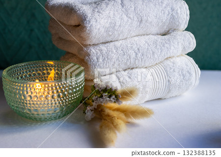Candles, towels, and wildflowers in an aesthetic arrangement.Horizontal shot. Natural light Candles, towels, and wildflowers in an aesthetic arrangement.Horizontal shot. Natural light 132388135
