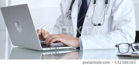 Doctor hands typing on laptop keyboard, offering online remote consultation or digital medical assistance, focused on treatment. Medicine, healthcare and science concept 132388163
