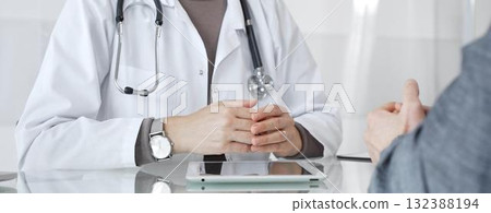 Female doctor consulting patient, explaining treatment options, discussing healthcare in clinic, providing medical advice. Medicine and health care 132388194