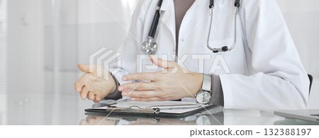 Doctor discussing medical treatment with patient during healthcare consultation, offering advice in clinic. Medicine and health care 132388197