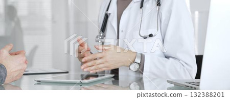 Female doctor consulting patient, explaining treatment options, discussing healthcare in clinic, providing medical advice. Medicine and health care Female doctor consulting patient, explaining treatment options, discussing healthcare in clinic, providing medical advice. Medicine and health care 132388201