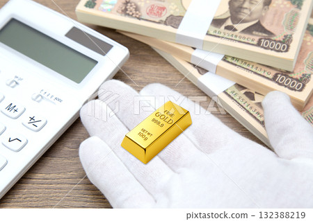 Gold ingot, stack of bills and calculator Gold ingot, stack of bills and calculator 132388219