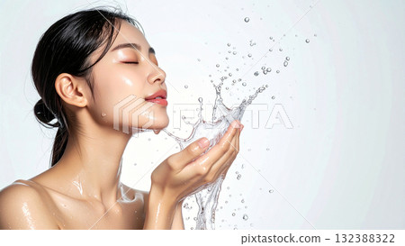 A woman washing her face in the morning spray of water creates a sense of calm and renewal in her skincare and morning routine 132388322