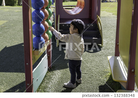 A boy playing with park play equipment A boy playing with park play equipment 132388348