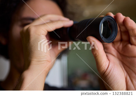 A Person Diligently Using a Telescope for Detailed Observation of the Night Sky and Beyond A Person Diligently Using a Telescope for Detailed Observation of the Night Sky and Beyond 132388821