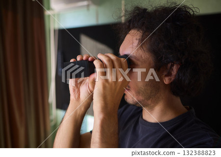 A Person Diligently Using a Telescope for Detailed Observation of the Night Sky and Beyond A Person Diligently Using a Telescope for Detailed Observation of the Night Sky and Beyond 132388823