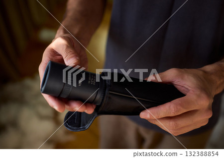 A Person Diligently Using a Telescope for Detailed Observation of the Night Sky and Beyond 132388854