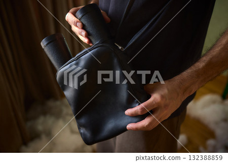 This stylish black bag features unique handles, making it perfect for trendy outfits and occasions 132388859