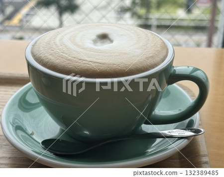 Softly foamy cafe au lait on a cafe table Softly foamy cafe au lait on a cafe table 132389485