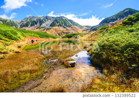 The beautiful reflection of Midorigaike Pond and the stunning autumn scenery of the Tateyama mountain range, Tateyama Kurobe Alpine Route, Murododaira, Toyama Prefecture The beautiful reflection of Midorigaike Pond and the stunning autumn scenery of the Tateyama mountain range, Tateyama Kurobe Alpine Route, Murododaira, Toyama Prefecture 132389522