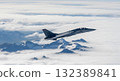 Military Jet Aircraft Soaring Above Clouds And Snow Capped Mountains In Mid Air 132389841