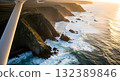 Aerial Coastal Cliffs Meeting Ocean Waves During Golden Hour Sunlight 132389846
