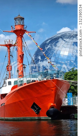 Kaliningrad, Russia, Museum of the World Ocean, ship "Vityaz" July 20, 2022 A bright red research ship with flags docked by a quay, set against a huge spherical, glass globe structure. Kaliningrad, Russia, Museum of the World Ocean, ship "Vityaz" July 20, 2022 A bright red research ship with flags docked by a quay, set against a huge spherical, glass globe structure. 132390534