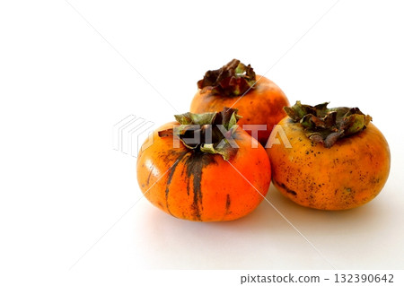 Imperfect persimmon on white background Imperfect persimmon on white background 132390642