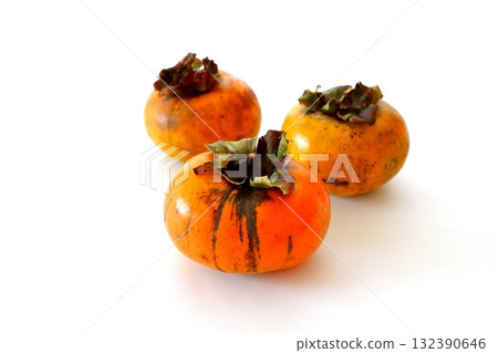 Imperfect persimmon on white background Imperfect persimmon on white background 132390646
