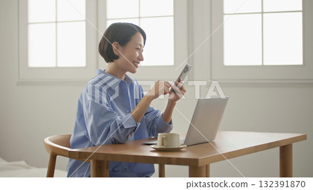 A woman using a computer (mobile phone operation) 132391870