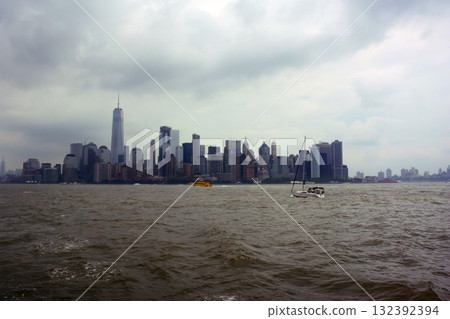 New York: Panoramic view of the tip of Manhattan Island under a cloudy sky 132392394