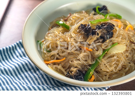 korean food japchae, Stir-fried Glass Noodles andVegetables, Glass noodles stir-fried with beef and assorted mushrooms and vegetables. A colorful classic dish that is always served at large gatherings 132393801