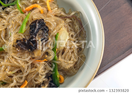 korean food japchae, Stir-fried Glass Noodles andVegetables, Glass noodles stir-fried with beef and assorted mushrooms and vegetables. A colorful classic dish that is always served at large gatherings 132393820