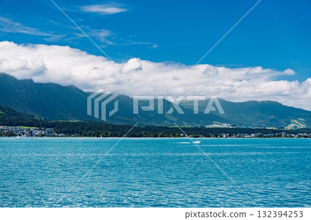 Scenic Alpine Lake Landscape with Mountains and Clouds, a Serene Natural Beauty 132394253