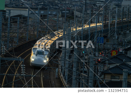 Nozomi Shinkansen bound for Tokyo Station. Winter sunset view from Shishikan Amusement Park. 15. Higashi Ward, Okayama City, Okayama Prefecture. Nozomi Shinkansen bound for Tokyo Station. Winter sunset view from Shishikan Amusement Park. 15. Higashi Ward, Okayama City, Okayama Prefecture. 132394731