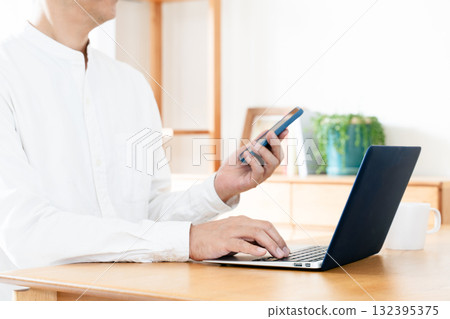 Hand of a man manipulating a smartphone Hand of a man manipulating a smartphone 132395375