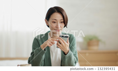 Woman operating a mobile phone 132395431