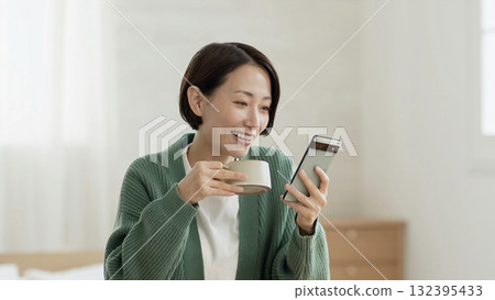 Woman operating a mobile phone 132395433