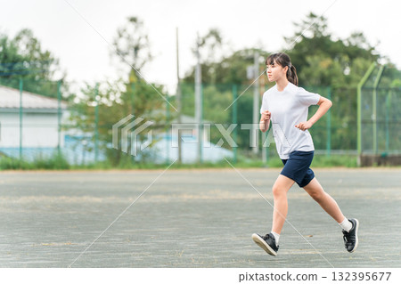 Junior high and high school girls running in the schoolyard (club activities, sports day, athletics festival, class match, track and field meet, track and field club) Junior high and high school girls running in the schoolyard (club activities, sports day, athletics festival, class match, track and field meet, track and field club) 132395677