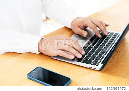 Hand of a man manipulating a smartphone Hand of a man manipulating a smartphone 132395972