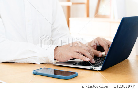 Hand of a man manipulating a smartphone 132395977