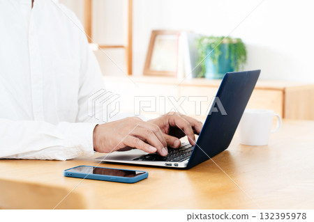 Hand of a man manipulating a smartphone Hand of a man manipulating a smartphone 132395978