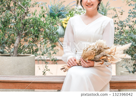 Woman in wedding dress on courtyard, patio, bride 132396042