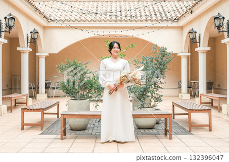 A woman in a wedding dress in a courtyard, patio, bride, bride (Nordic, Europe) 132396047