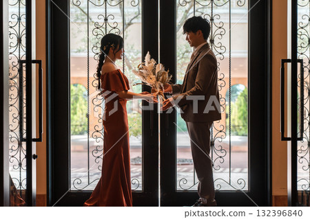 Proposal, wedding reception, after-party, bride and groom appearing in colorful wedding dresses, dressed-up couple 132396840