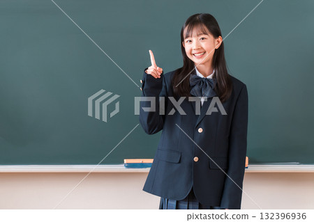 Female elementary, junior high, and high school students in uniforms making the number 1 sign in front of the classroom blackboard (countdown) 132396936