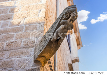 Stone corbel featuring female figure on brick building in Korcula Stone corbel featuring female figure on brick building in Korcula 132397595