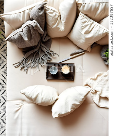 Cozy Beige Couch Haven with Pillows, Throws, Tray, and Serene Candle Light 132397657